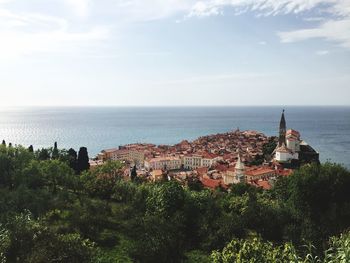 High angle view of buildings in town at coast 