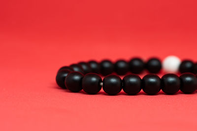 Close-up of colored pencils over red background