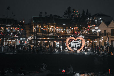 People on illuminated city at night