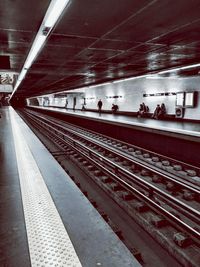 People waiting at railroad station platform