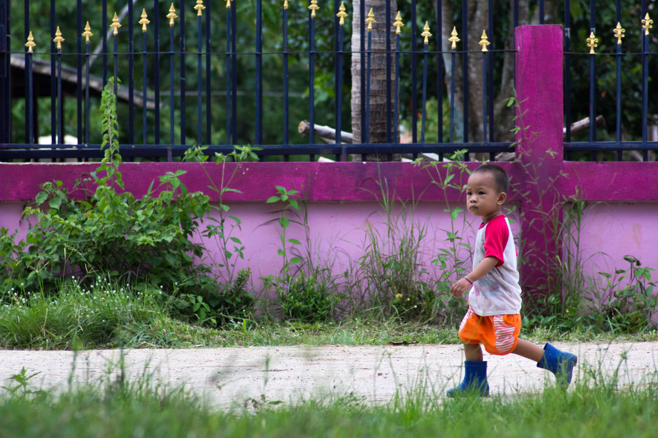 FULL LENGTH OF BOY STANDING IN WATER