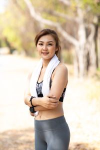 Portrait of smiling young woman standing outdoors