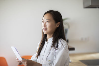 Young asia female doctor with report in a practice