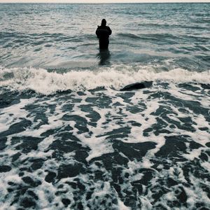 Rear view of man standing on beach