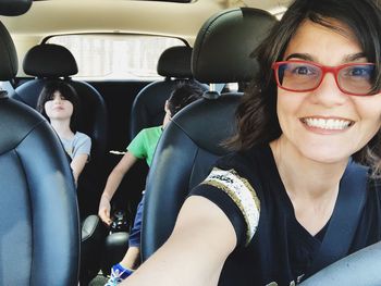 Portrait of smiling woman sitting in car