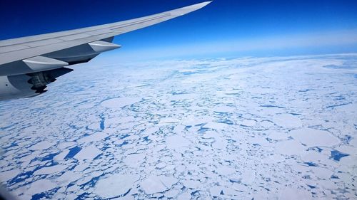 Cropped image of airplane flying over landscape