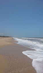 Scenic view of beach against clear sky