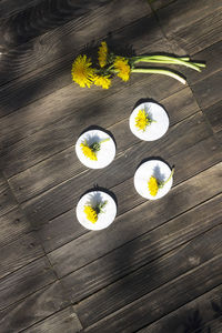 High angle view of yellow flower on table