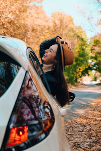 Side view of young woman standing on road