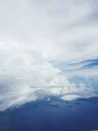 Scenic view of mountains against cloudy sky