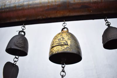 Close-up of old bell hanging outside temple