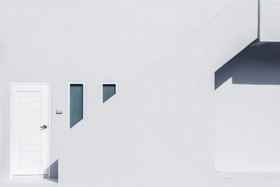 Whitewashed building in town during sunny day