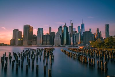 Panoramic view of sea and buildings against sky during sunset