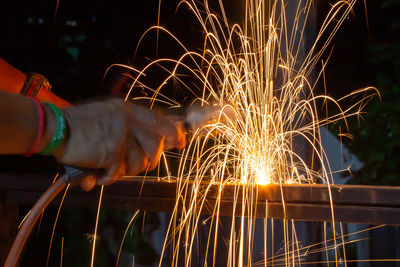 Low angle view of firework display at night