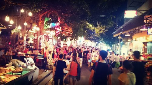 Crowd at market in city at night