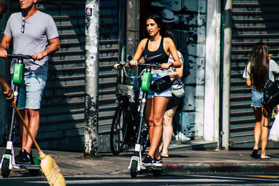 Full length of woman standing on street in city