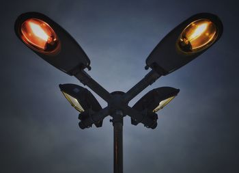 Low angle view of illuminated street light against clear sky