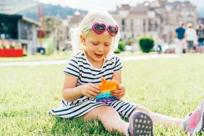 Portrait of cute boy sitting outdoors