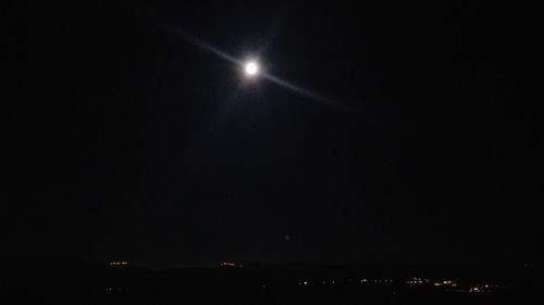 Illuminated lights against sky at night