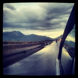 Scenic view of mountains against cloudy sky