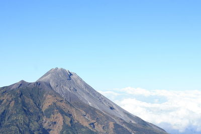 Scenic view of mountains against blue sky