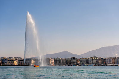 View of fountain in city against sky