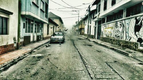 Cars on street amidst buildings in city