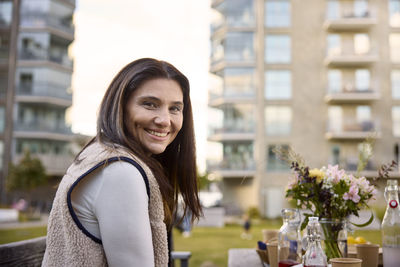 Smiling woman at table looking at camera