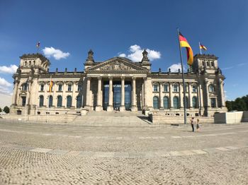 Facade of historical building in city against sky