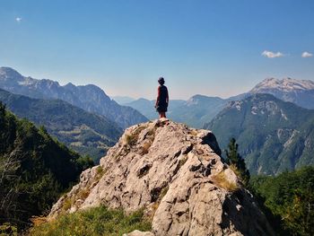 Man standing on rocks against mountains