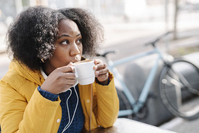 Young woman drinking coffee cup