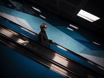 High angle view of woman standing by railing