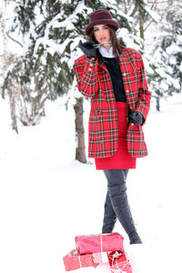 Full length of woman standing in snow