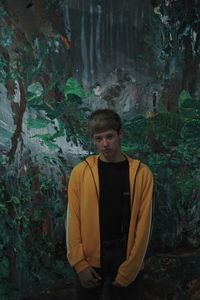 Portrait of teenage girl standing in forest