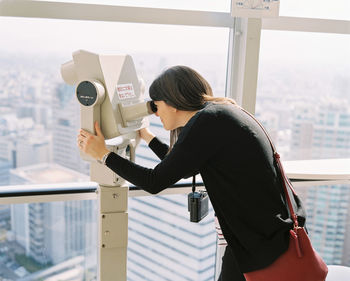 Side view of woman photographing