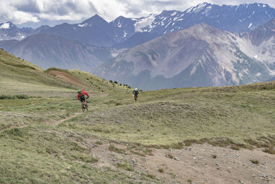 Rear view of man on mountains against sky