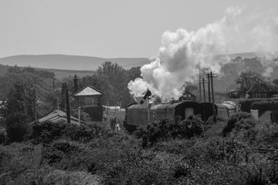 Smoke emitting from steam train against sky