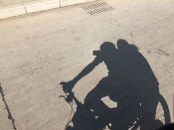 High angle view of friends shadow on street