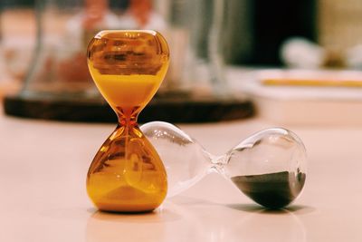 Close-up of hourglasses on table