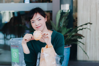 Portrait of woman holding ice cream