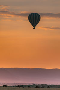 Hot air balloon against orange sky