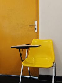 Empty chairs and table against wall at home