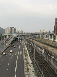 High angle view of railroad tracks by road against sky