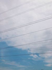 Low angle view of electricity pylon against sky