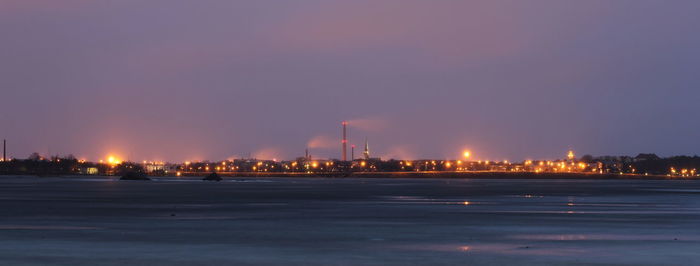 Smoke emitting from factory against sky at night