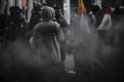 Rear view of people standing on street