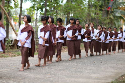 Group of people walking in row