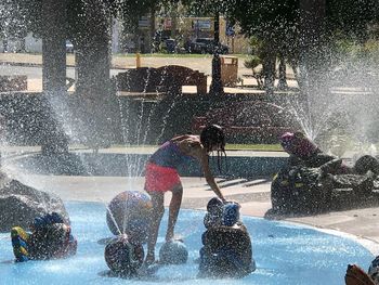 People playing fountain in water