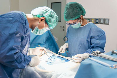 Surgeons operating patient in hospital