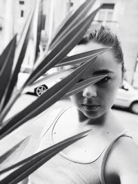 Close-up portrait of young woman standing outdoors